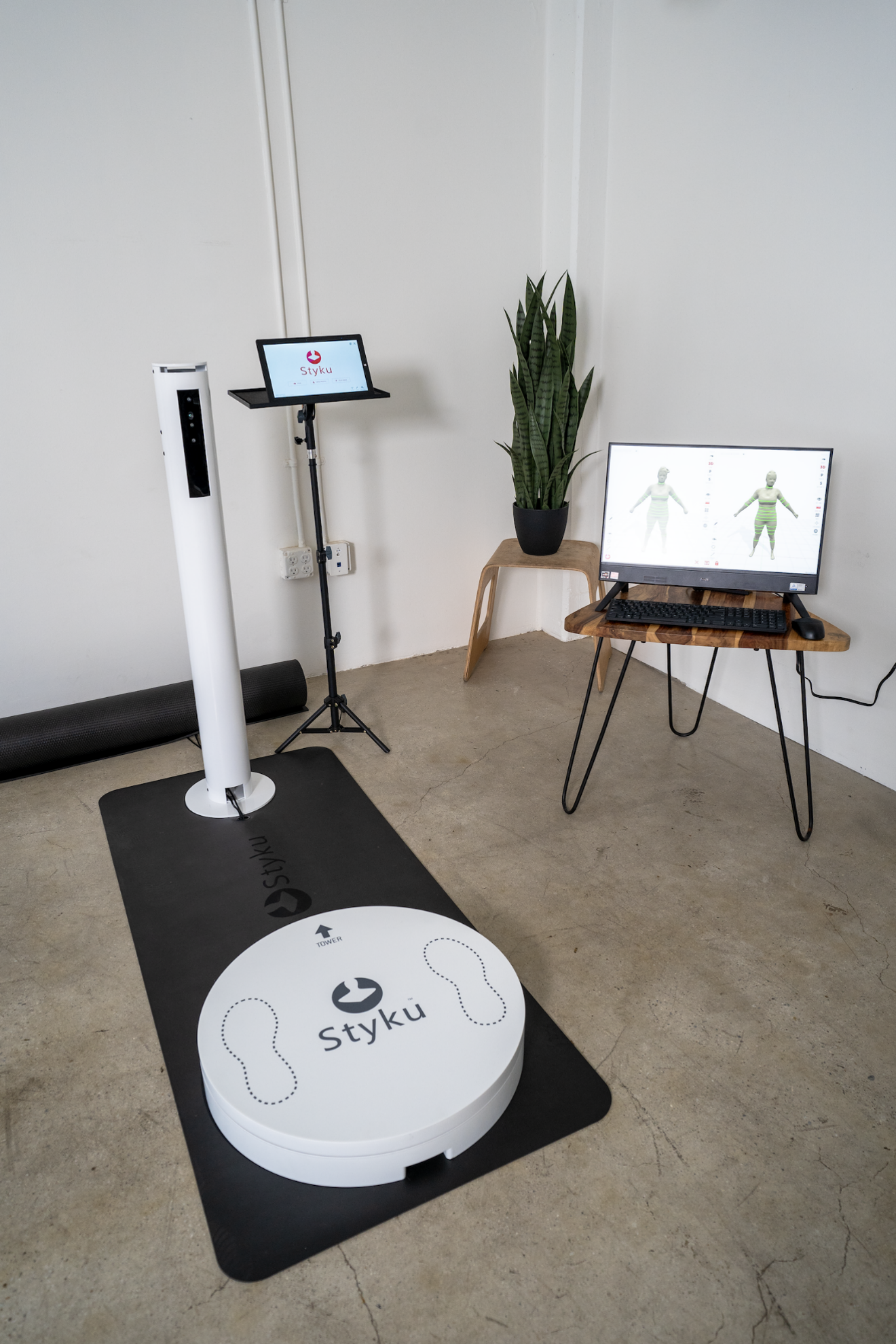 Styku body scanner platform with tablet and 3D scan results on a monitor