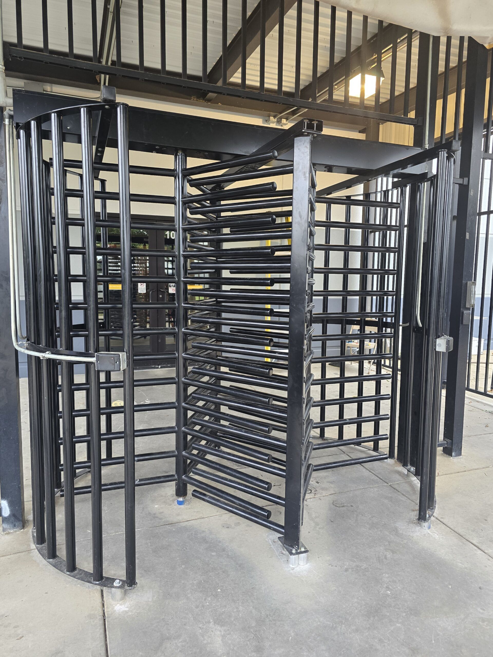 Black metal turnstile at a building entrance.
