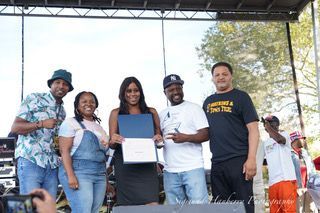 A group of people are standing on a stage holding a certificate.