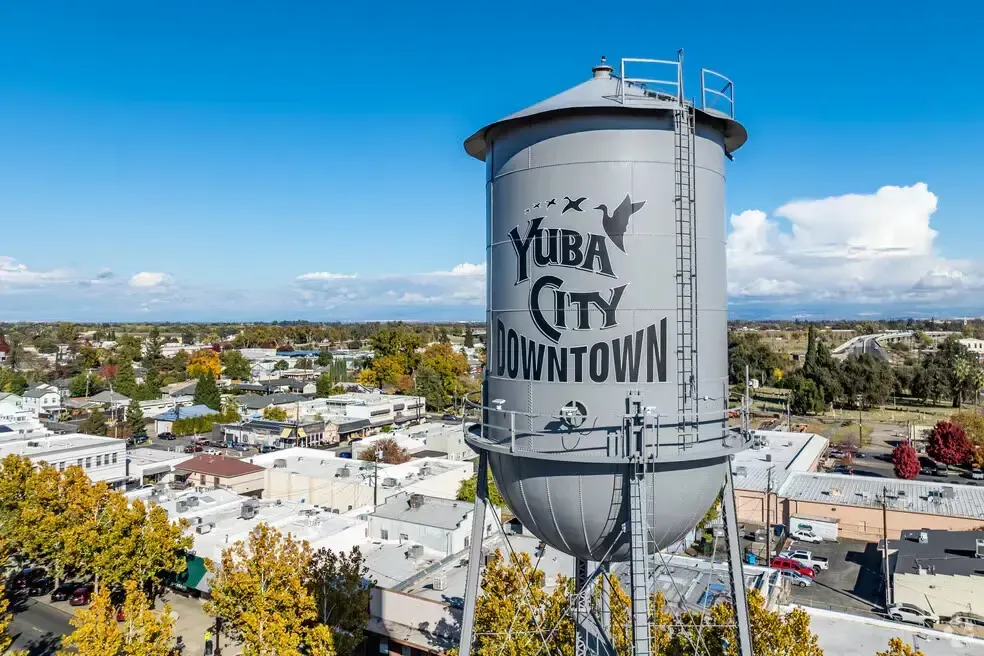 Tuba City water tower above a residential neighborhood under a bright blue sky