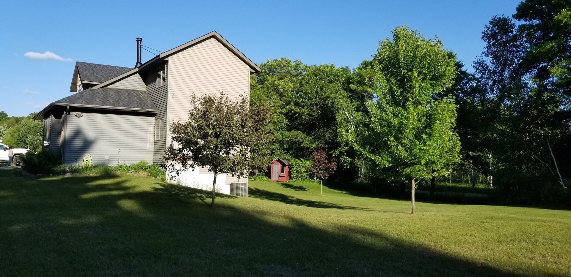 A large house with a lot of trees in front of it