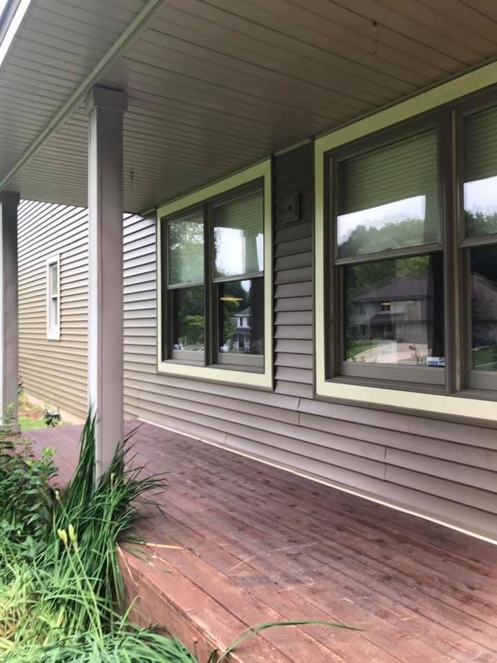A house with a porch and a lot of windows.