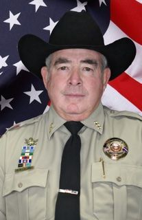 A man in a suit and tie is smiling for the camera.