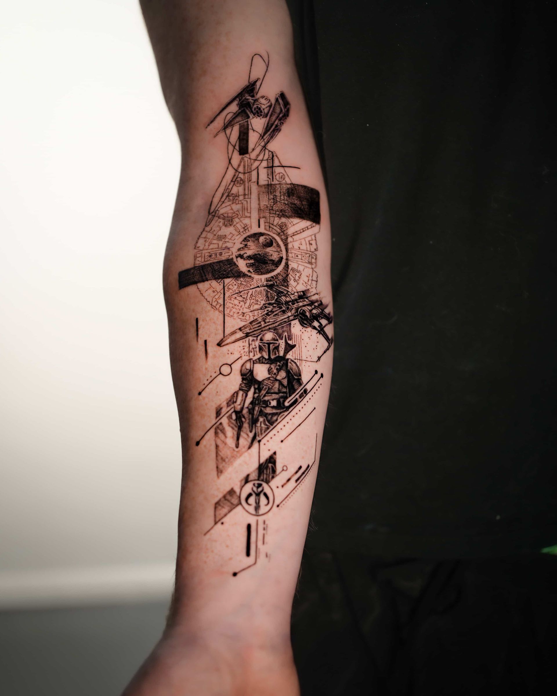 Tattoo of a Star Wars scene on an arm. Abstract style with a stormtrooper and symbols. Black ink.