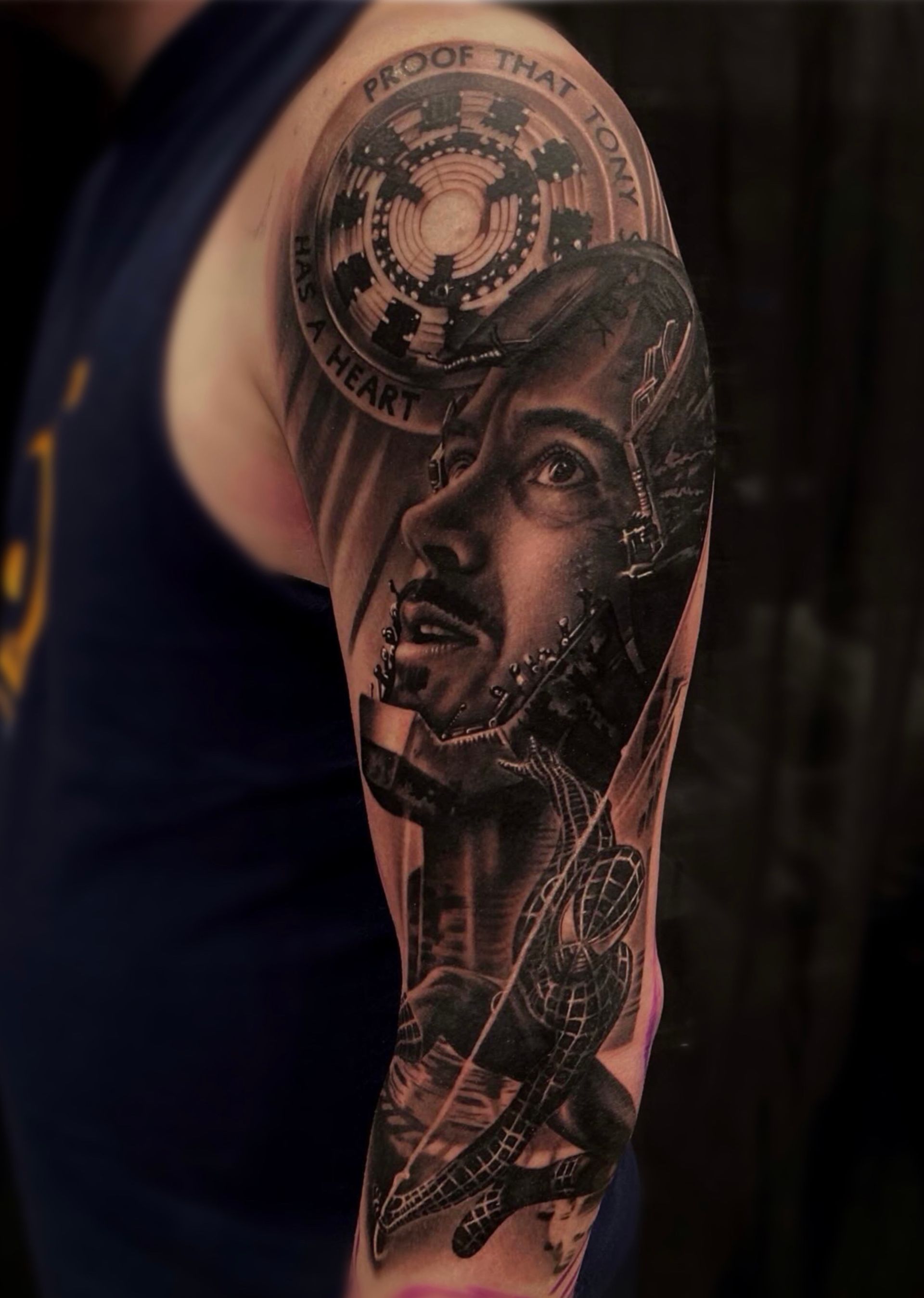 A man has a tattoo of a man 's face on his arm.