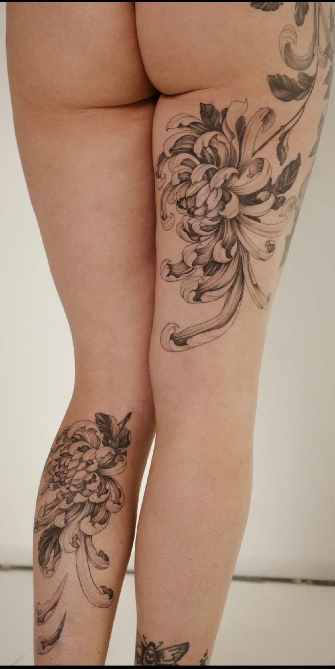 Legs and rear with floral tattoos.