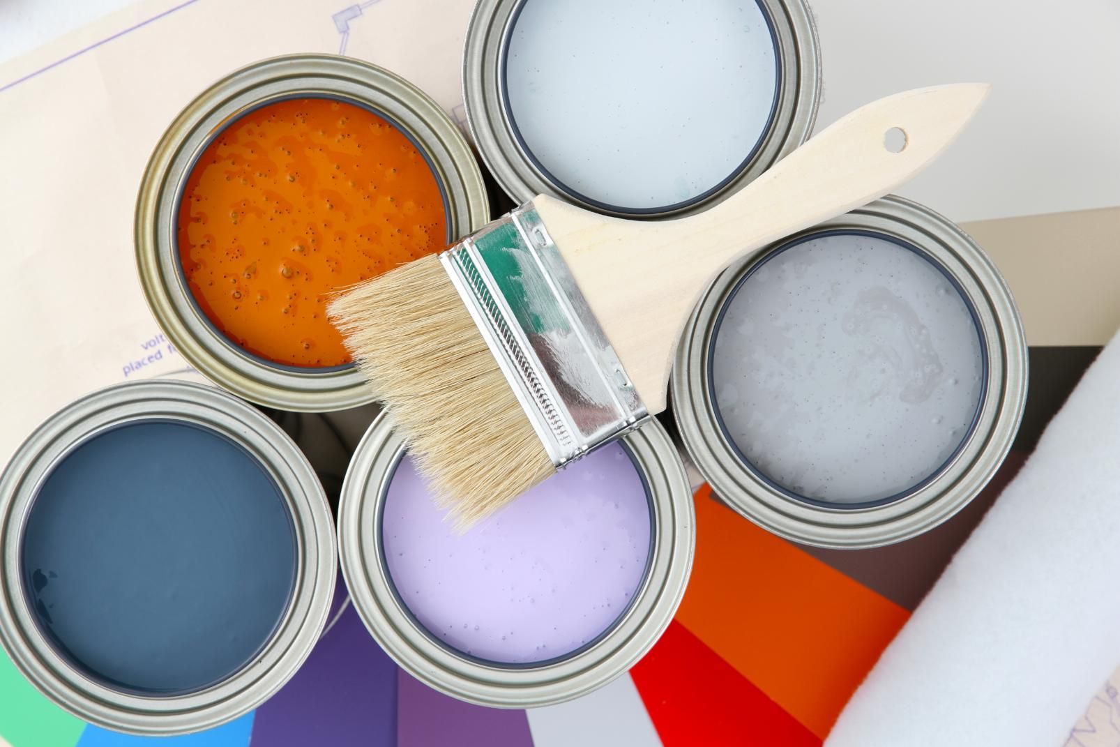 A Brush is Sitting on Top of a Pile of Paint Cans — D’Art Interiors in Eureka, NSW