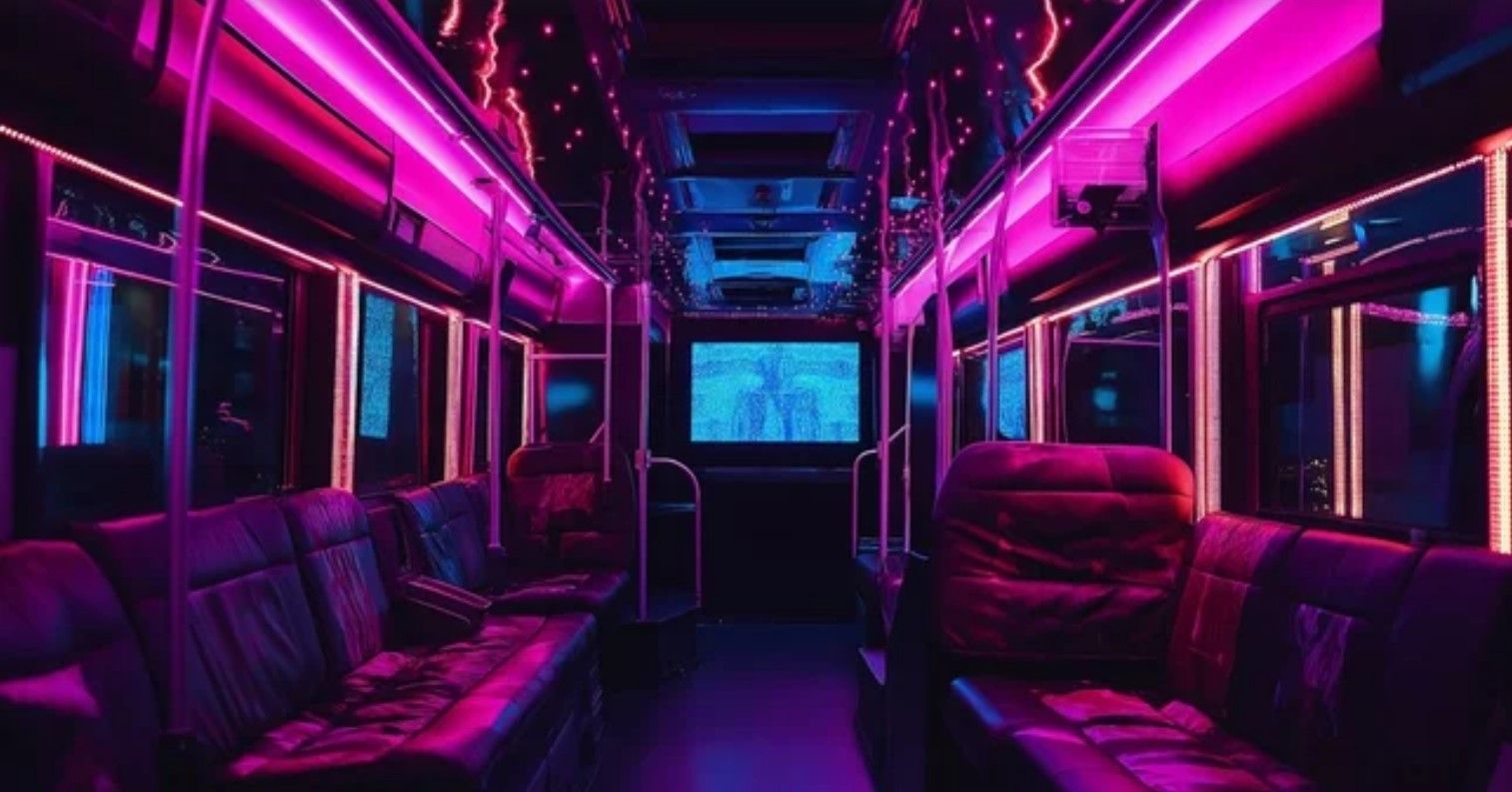 The inside of a bus with purple and blue lights.