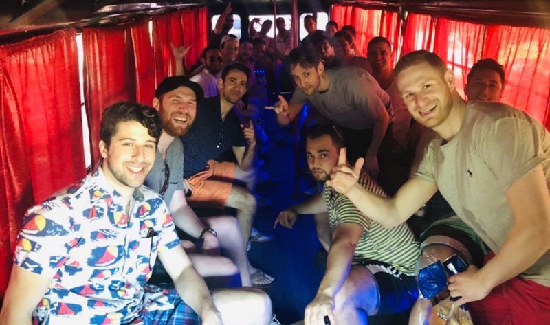 A group of men are posing for a picture in a bus.