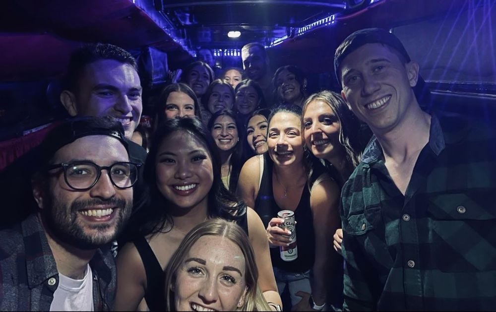 A group of people are posing for a picture on a bus.