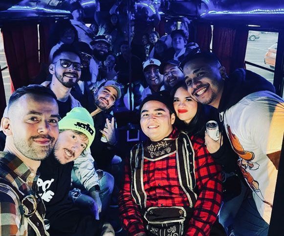 A group of people are posing for a picture on a bus.