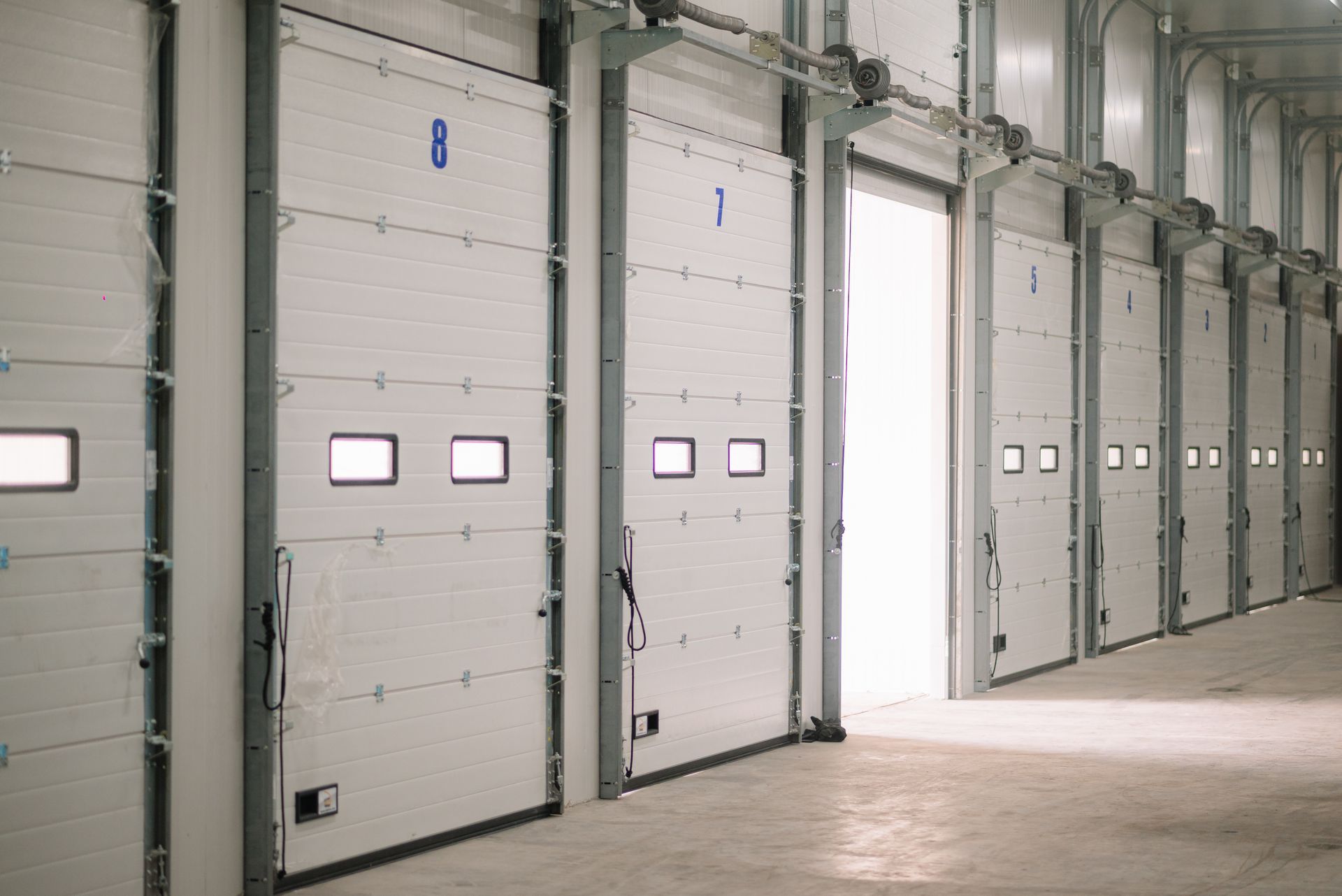 Dependable overhead garage door supplier with insulated white warehouse doors interior. Dependable overhead garage door supplier with insulated white warehouse doors interior.