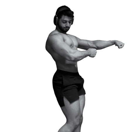 Kamal in black shorts is flexing his muscles
