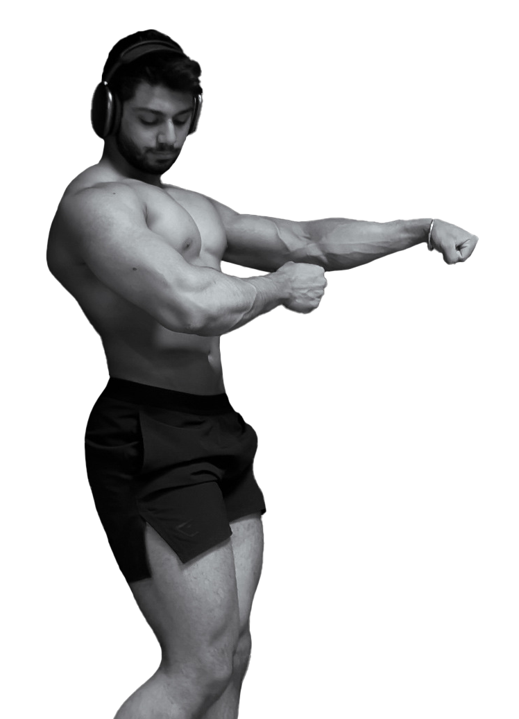Kamal wearing headphones is flexing his muscles in a black and white photo.