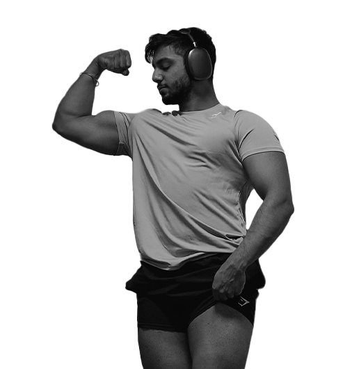 Kamal wearing headphones is flexing his muscles in a black and white photo