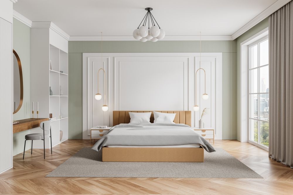 A bedroom with a bed , dresser , mirror and window.