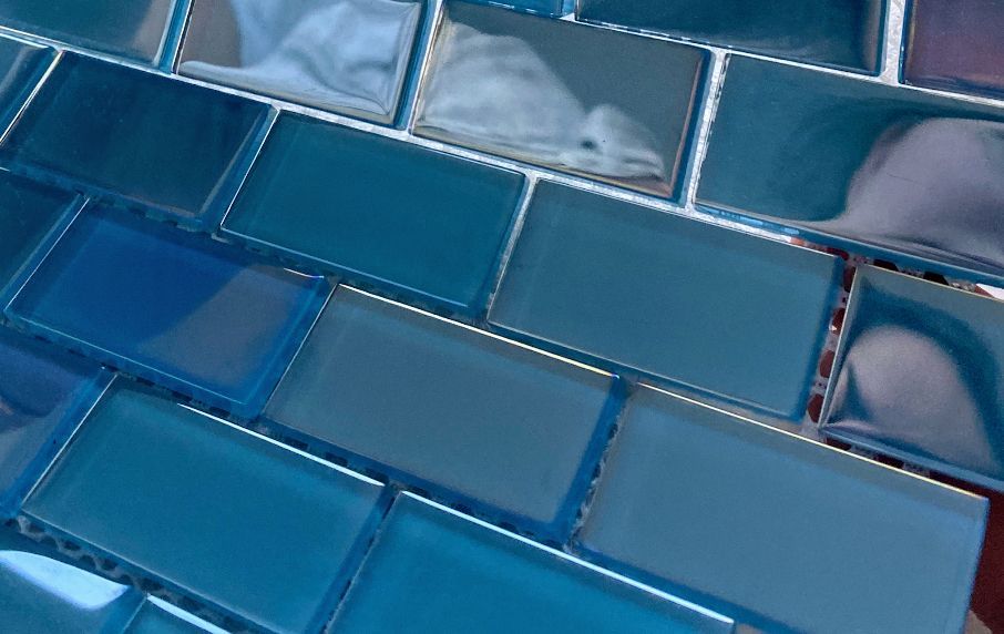 Blue and silver glass mosaic tiles with a glossy, reflective surface