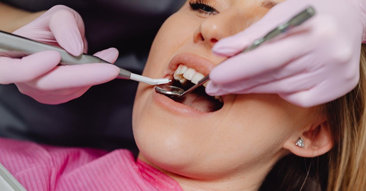 Dentist examining a patient’s teeth with dental tools during a checkup