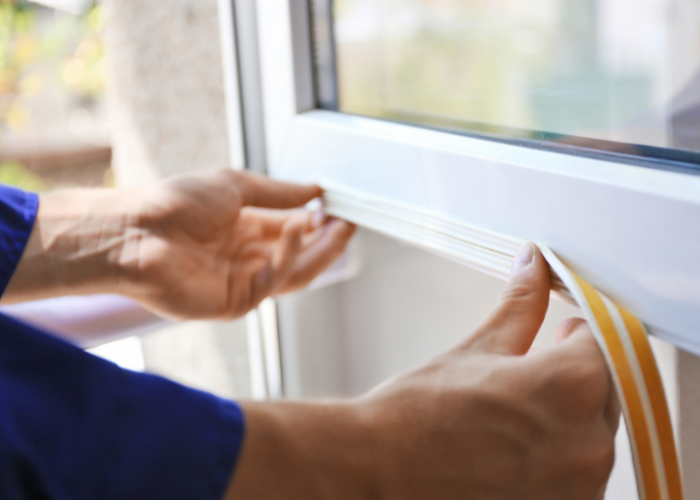 Person repairing trim on window