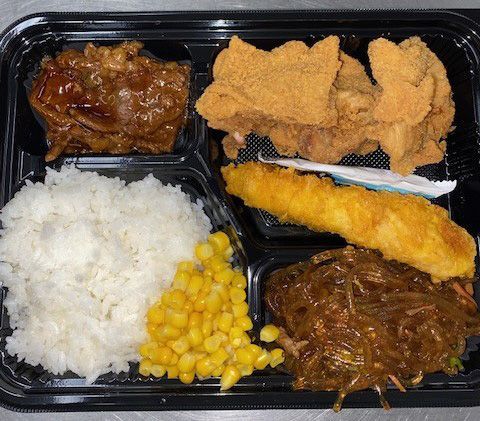 Lunch tray with rice, corn, fried fish, tempura, meat in sauce, and noodles
