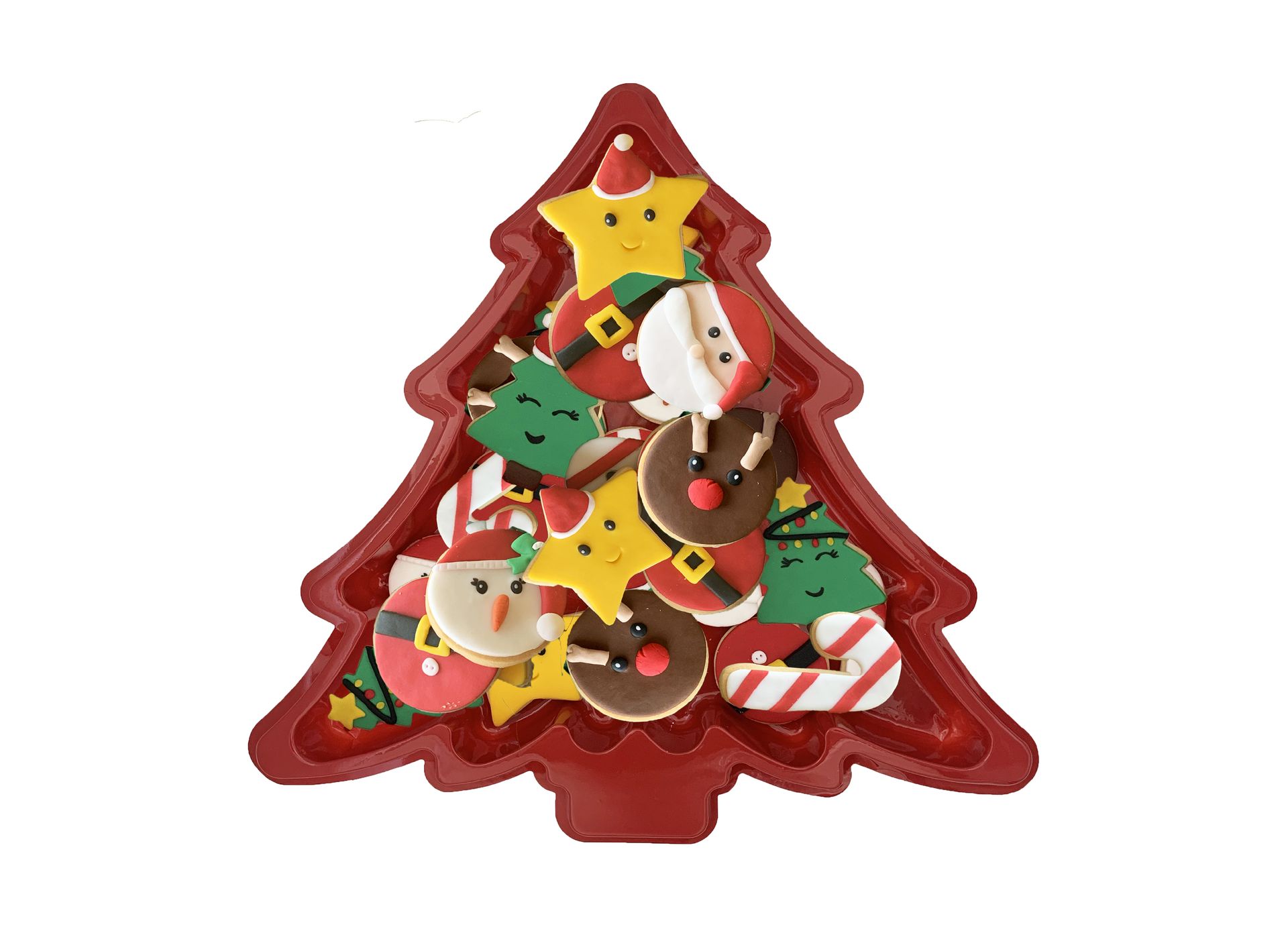 Christmas tree-shaped plastic thermoformed trays filled with festive cookies: stars, Santas, reindeer, and elves. Red and colorful.
