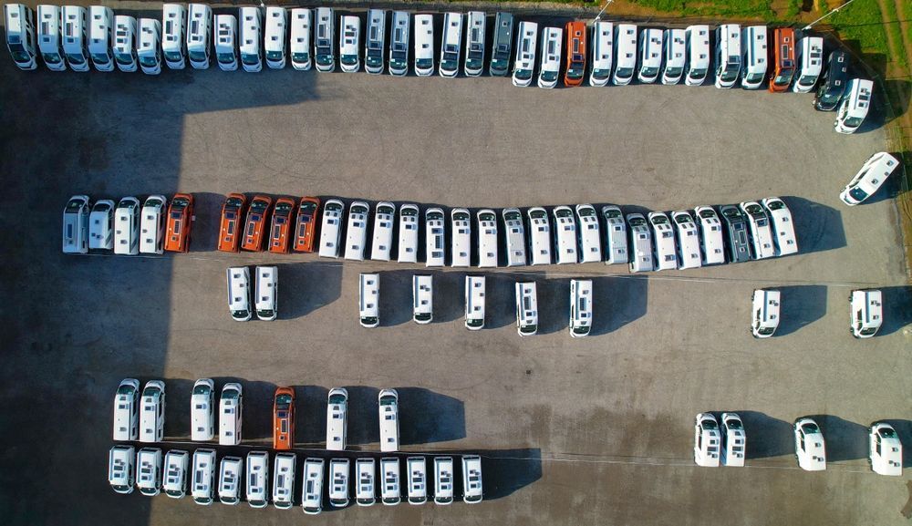 A row of cars are parked in a parking lot