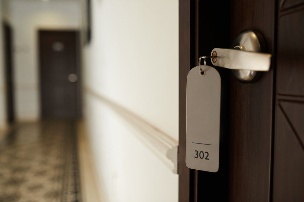 Motel Room with Key in A Lock and Hall — Aurora, IL — Hansen's Motel