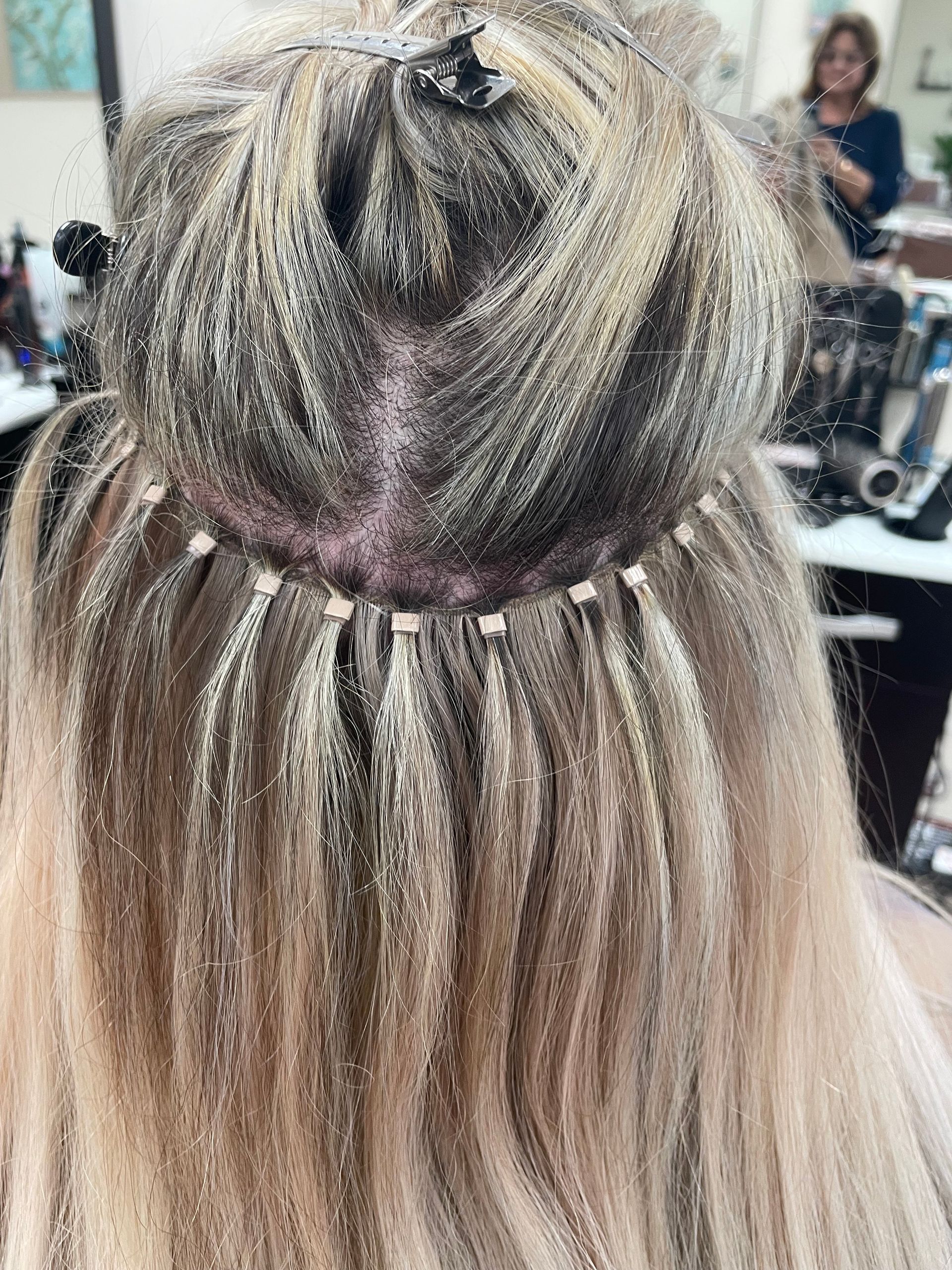 A woman is getting her hair done in a salon.