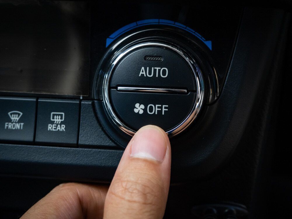 A Person Is Pressing A Button On A Car Air Conditioning System โ Tonics Automotive in Garbutt, QLD