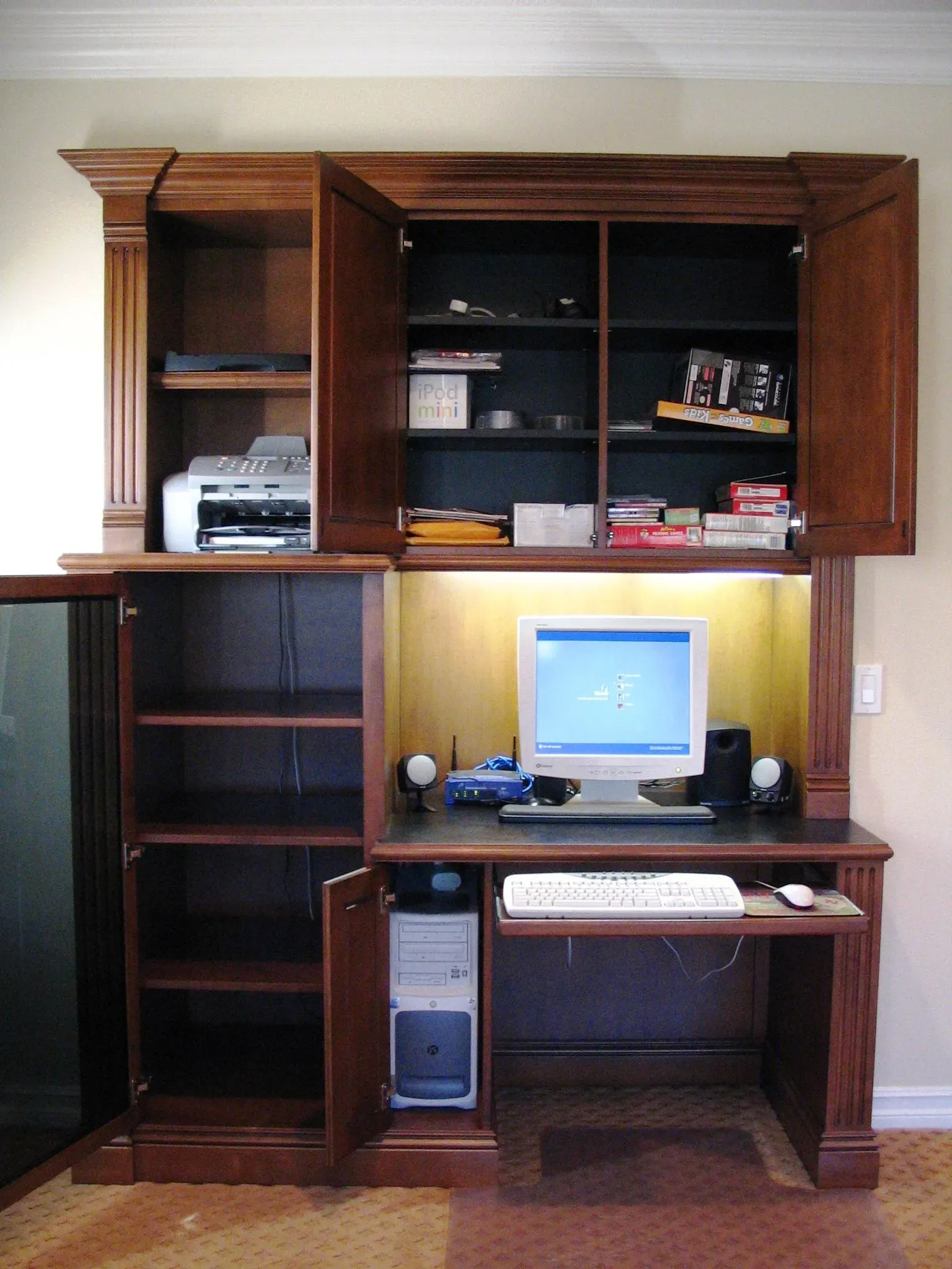 Wooden home office hutch with shelves, printer, and desktop computer desk setup
