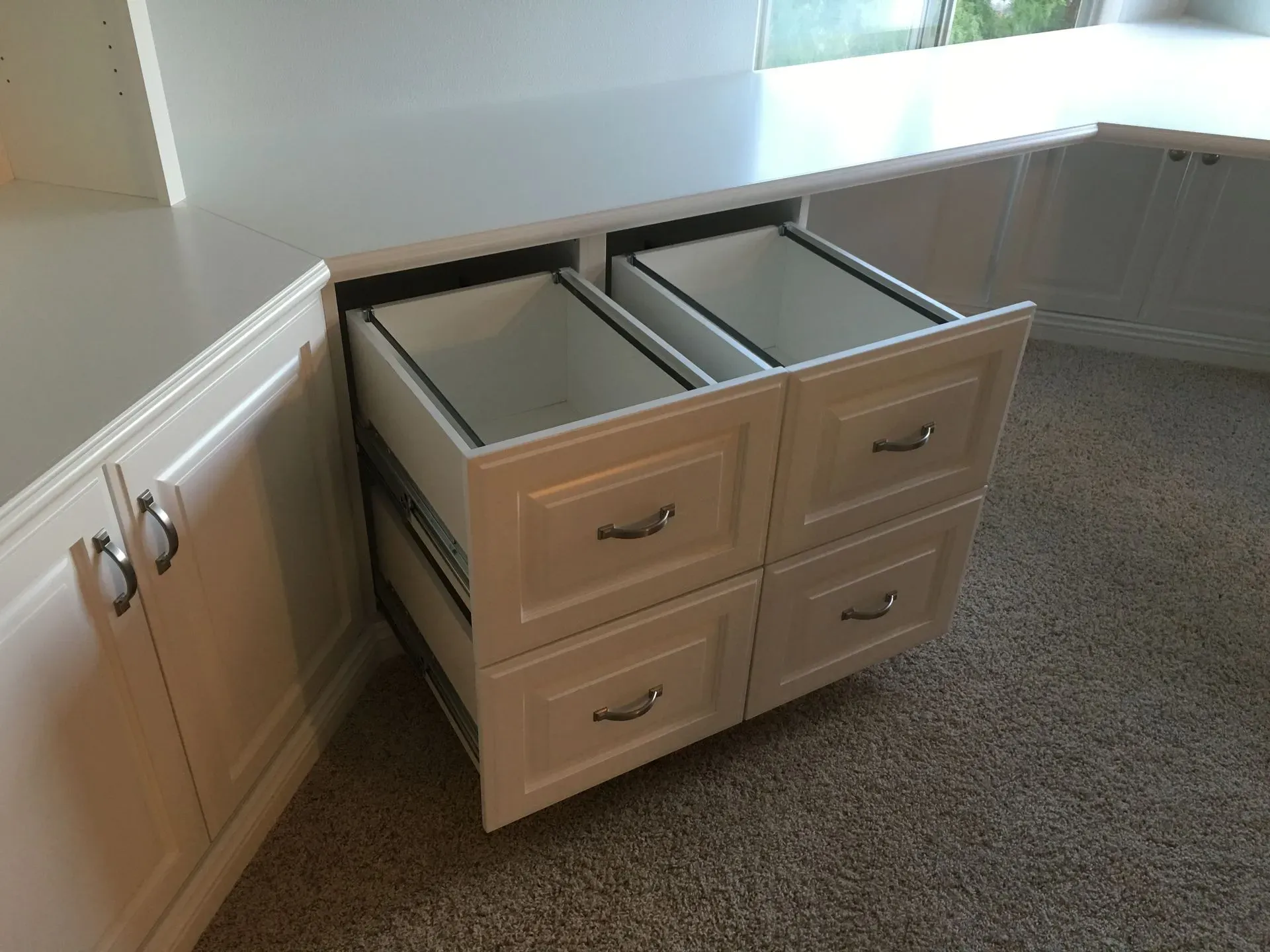Bathroom vanity with four drawers and two open storage bins under a countertop.
