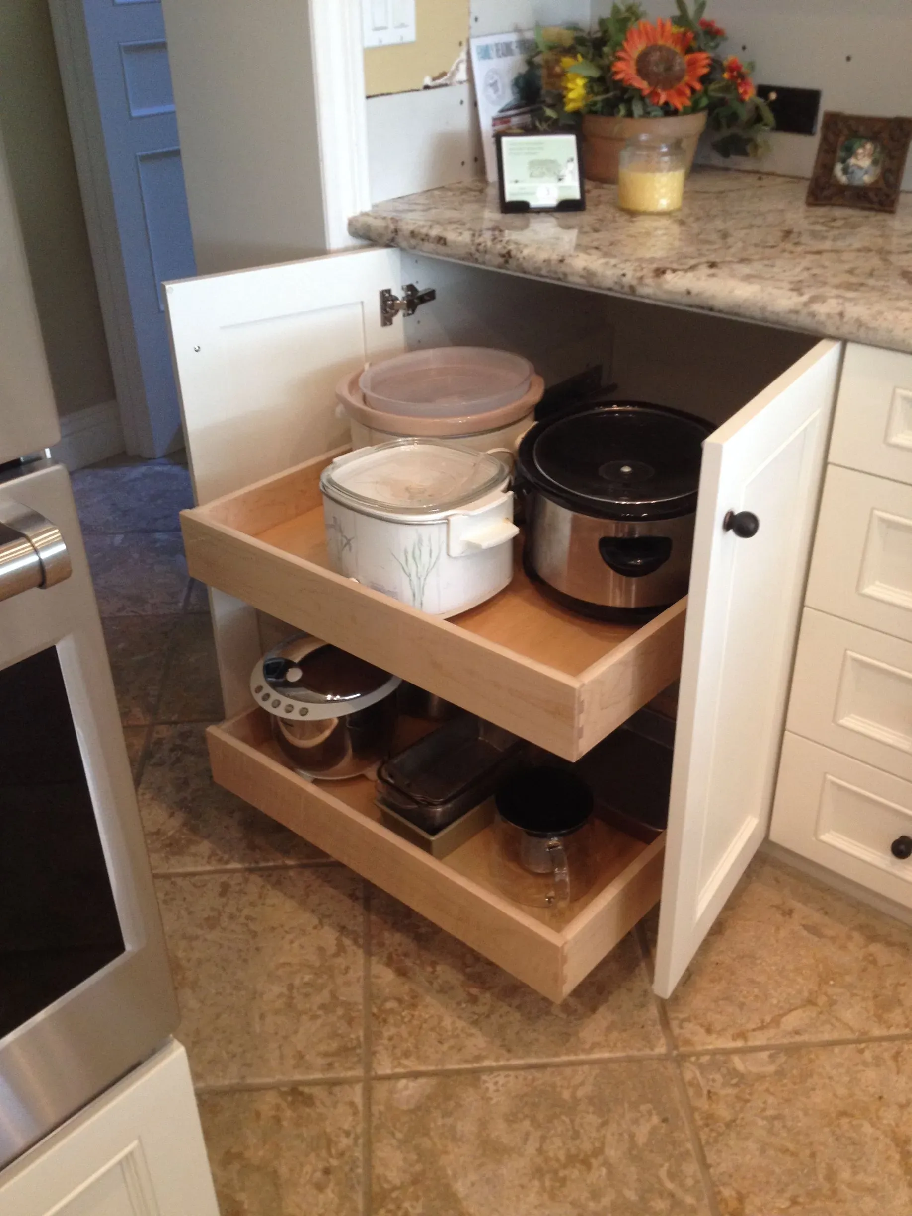 Kitchen cabinet pullout shelf with crockpot, rice cooker, and storage bins