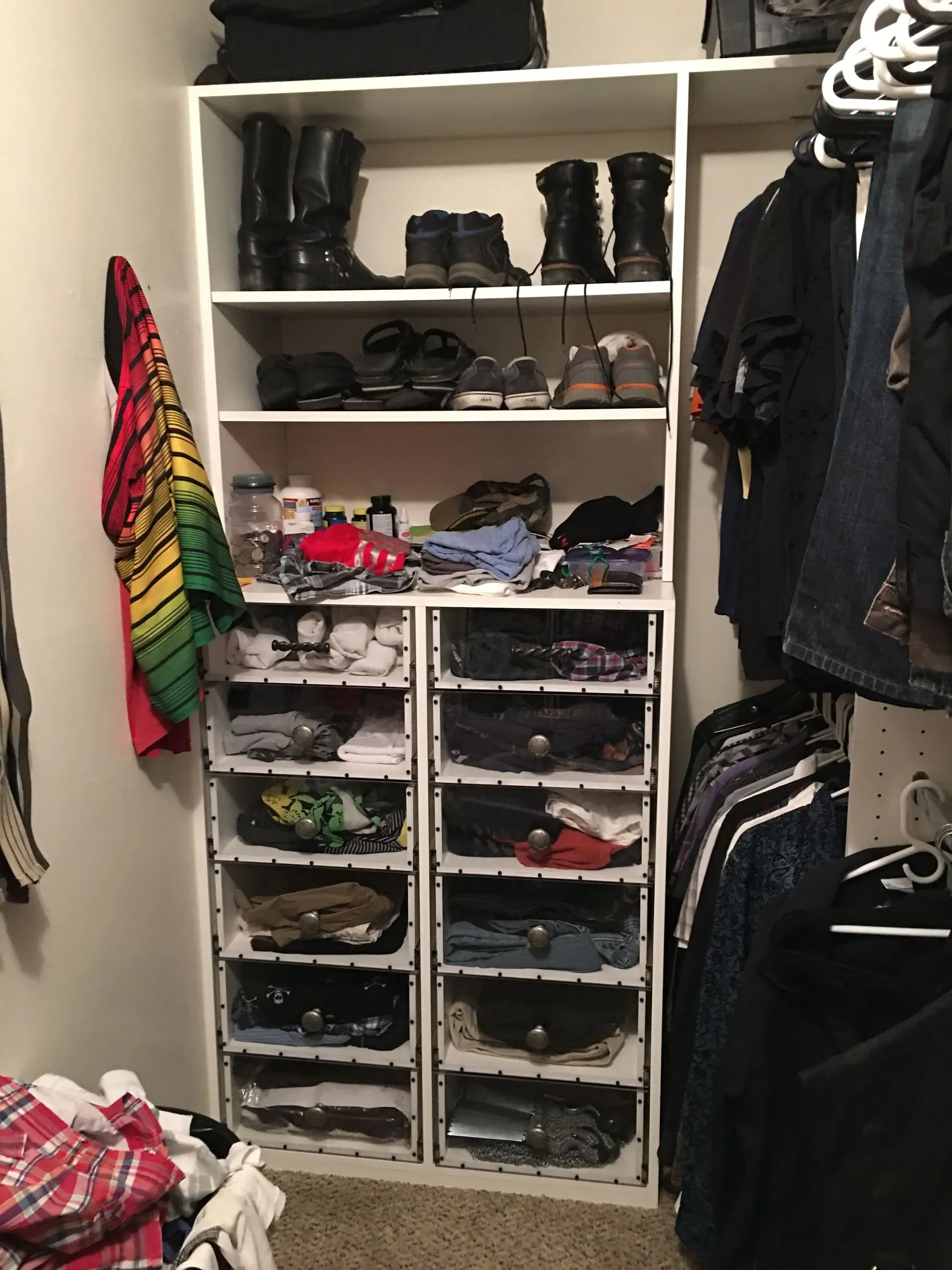 Closet with shelves and hanging clothes, neatly organized shoes, boots, and folded items.