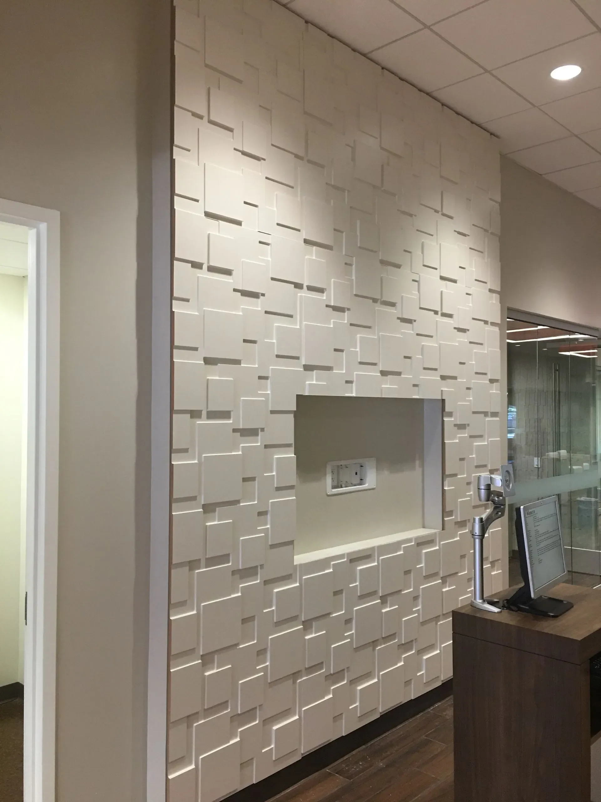 White textured accent wall with a recessed niche in a modern lobby or hallway