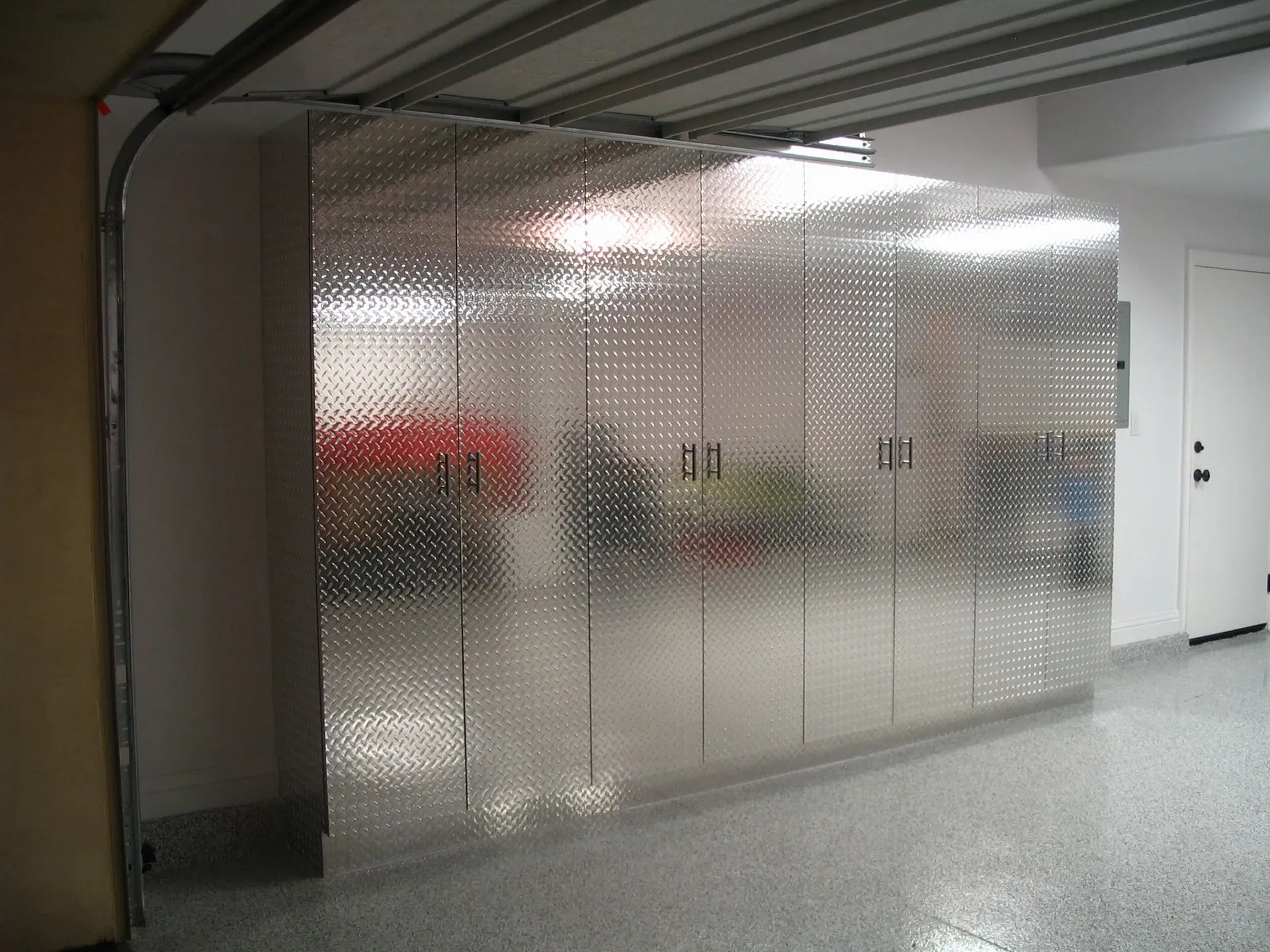 Frosted glass office partition in a hallway with blurred figures and red objects behind it