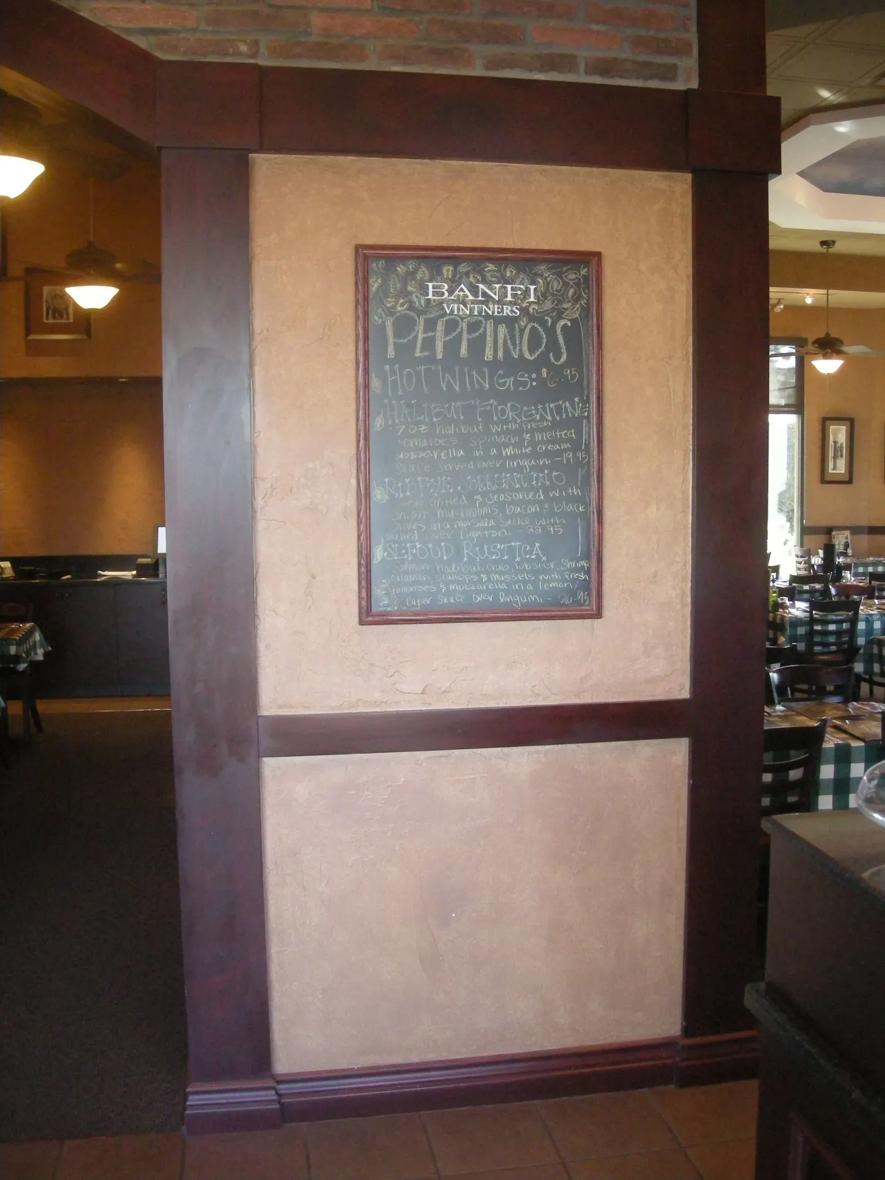 Restaurant wall with framed menu chalkboard in a beige and brown interior
