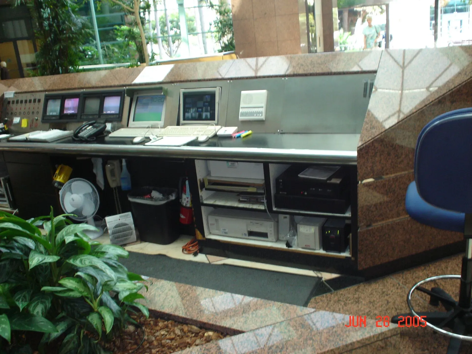 Computer workstation with multiple monitors and keyboards in a lobby or office area