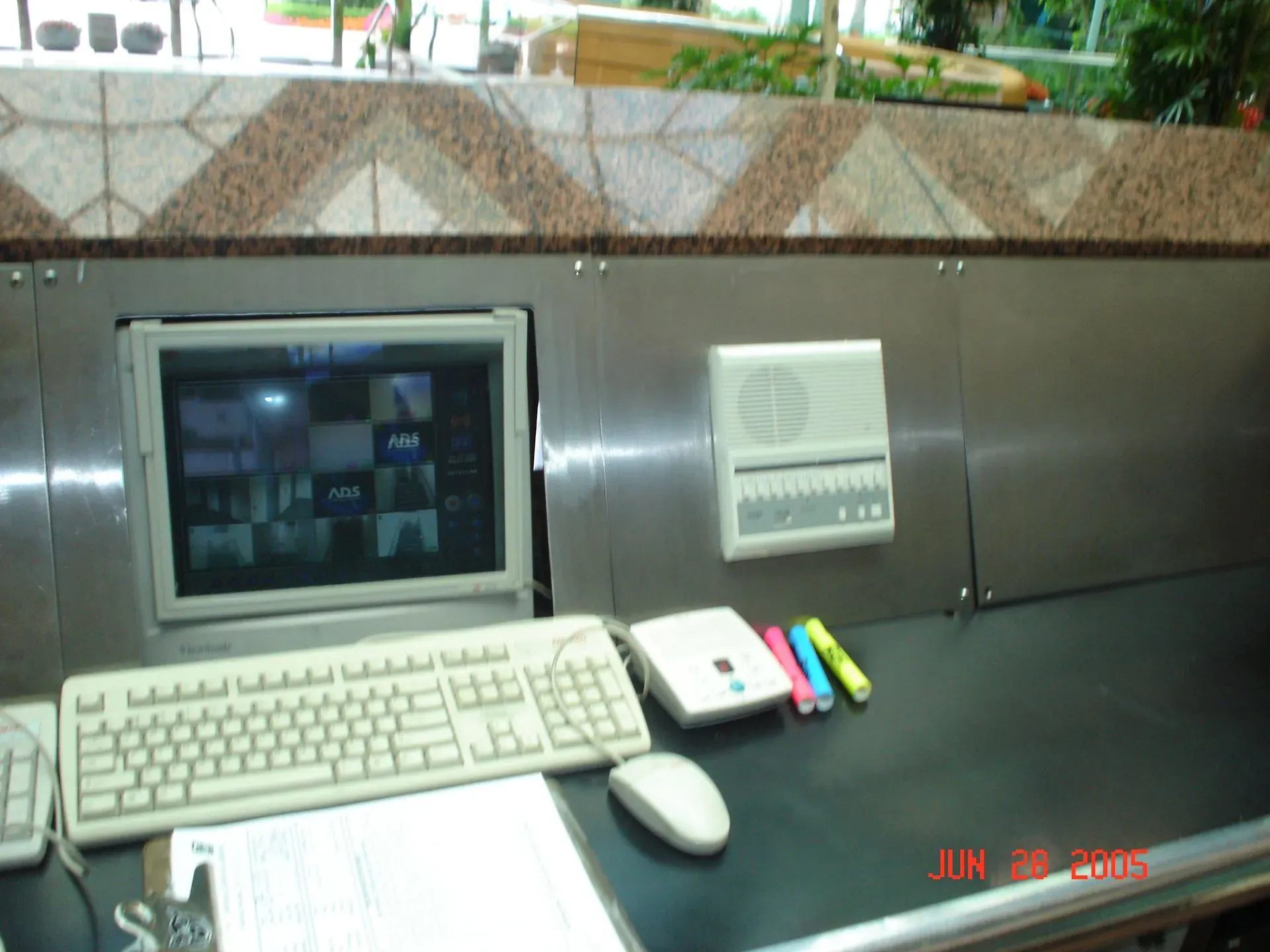 Desktop computer setup with CRT monitor, keyboard, mouse, and office supplies on a desk