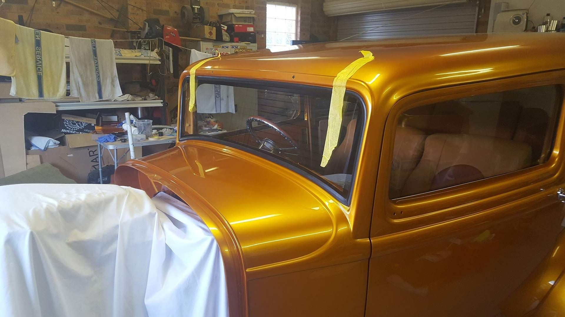 A Gold Car Is Sitting In A Garage — MJR Auto Glass In Goulburn, NSW