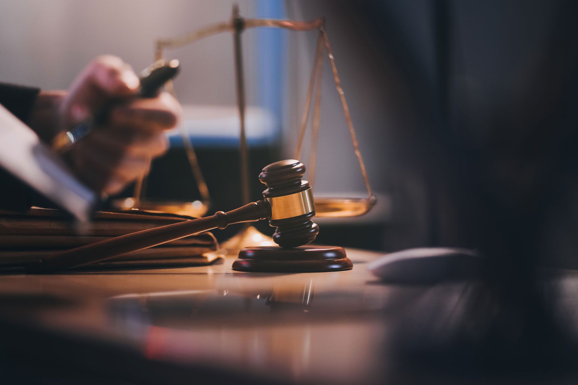 Scales of justice and a gavel on a desk in a law office