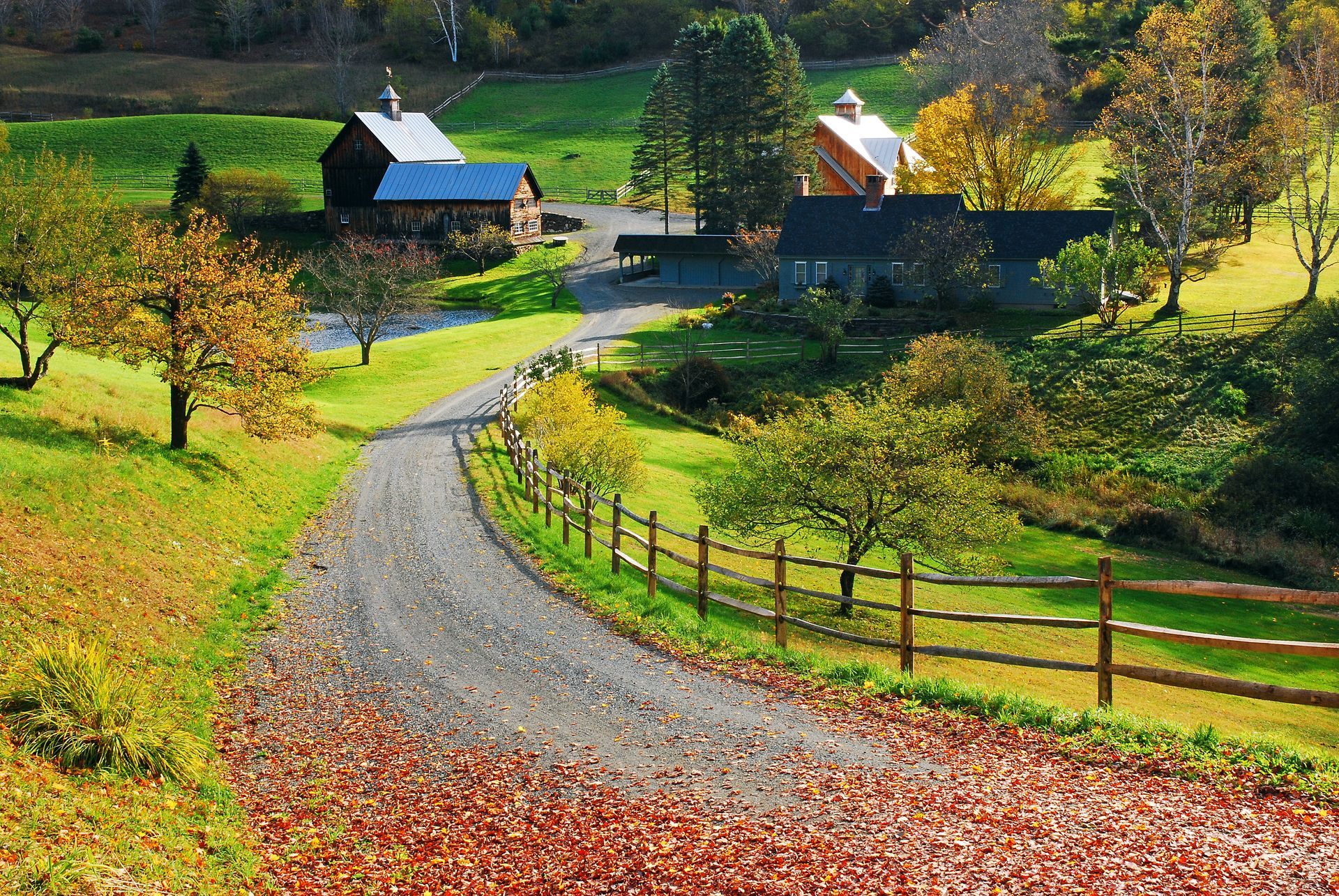 paved driveway to a farm property in the countryside