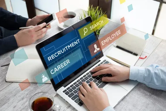A person is using a laptop computer to search for a job.