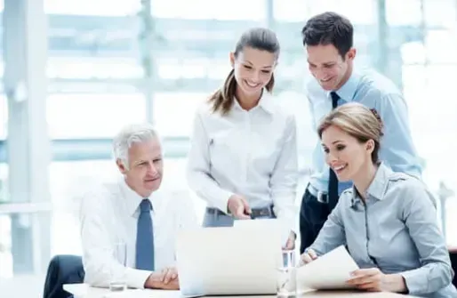 A group of people are looking at a laptop computer.