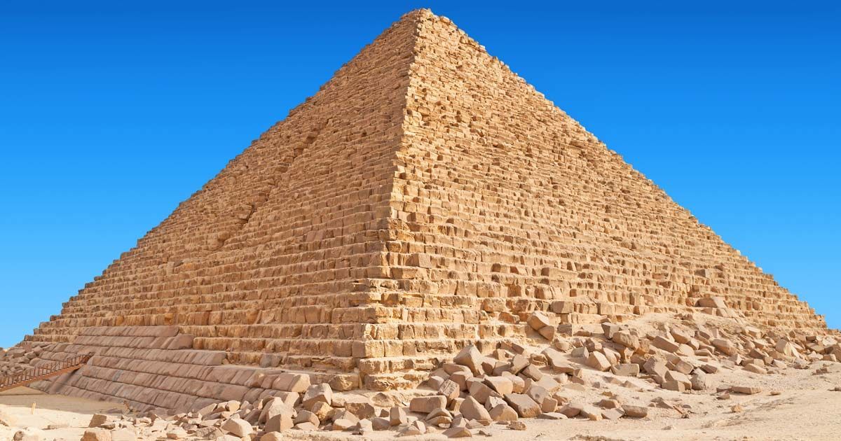 A large pyramid against a blue sky in the desert.
