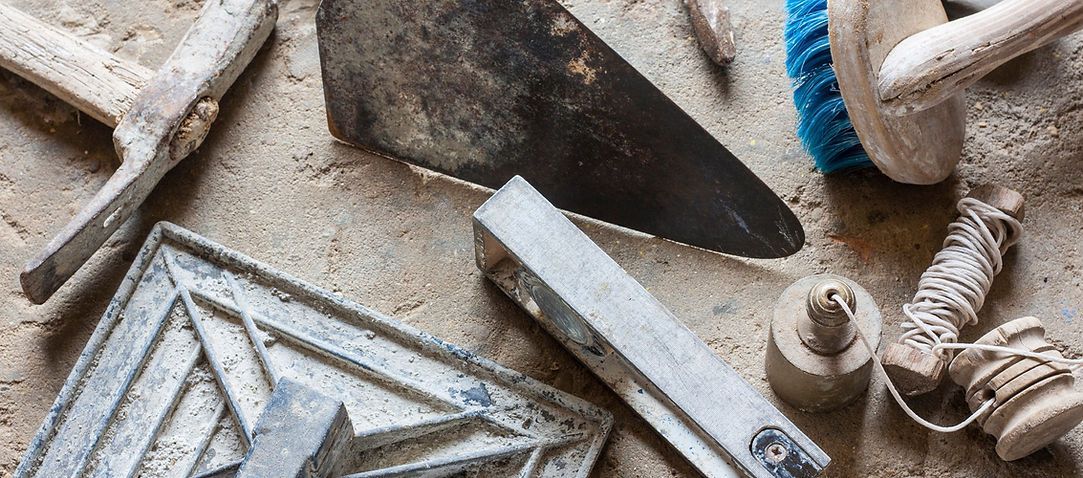 Dusty construction tools and building materials scattered on the ground