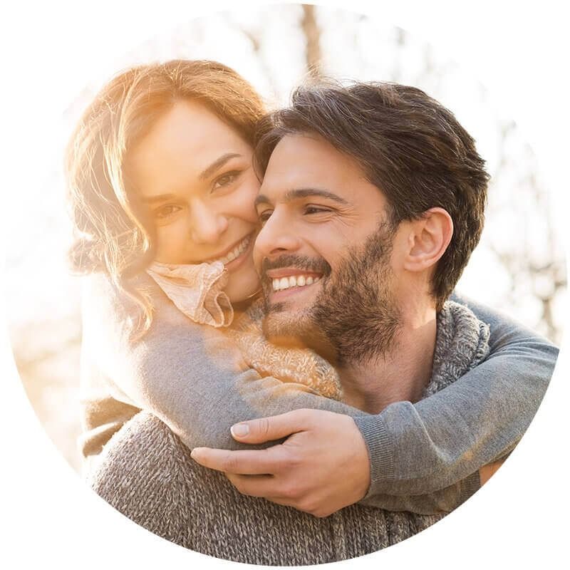 A Man is Carrying a Woman on His Back and They Are Smiling — Living Well Psychology Clinic in Erina, NSW