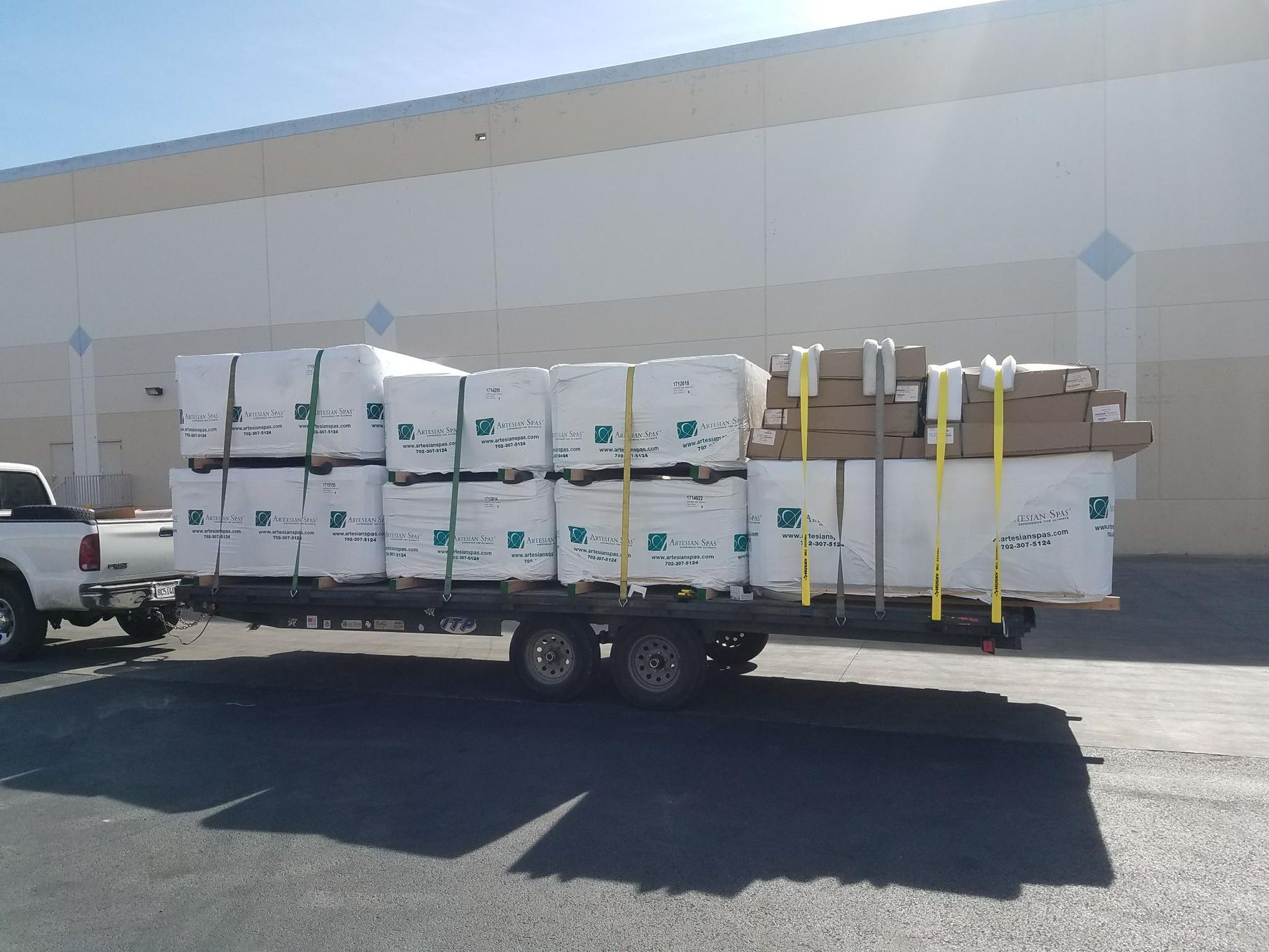 White delivery truck loaded with wrapped cargo parked on a residential street
