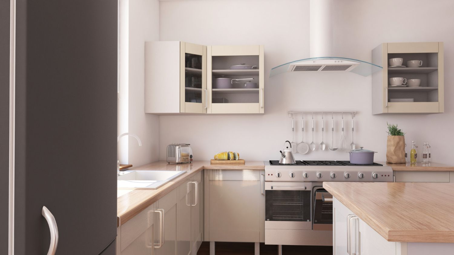 Small, bright kitchen with white cabinets, light wood countertops, and stainless steel appliances.