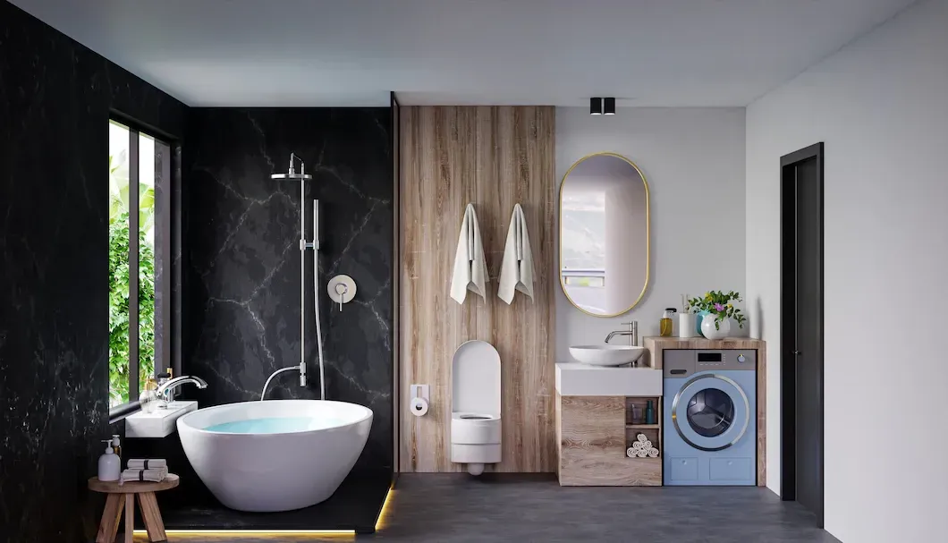 Modern bathroom with a bathtub, toilet, and sink; black marble wall and wooden accents.