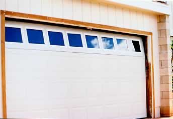 A white garage door with blue squares on it